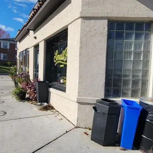 the outside of a restaurant with tables and chairs