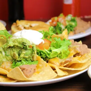 Our delicious supreme nachos topped with guacamole and sour cream.