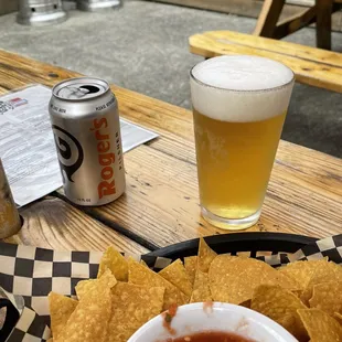 a bowl of chips and a beer