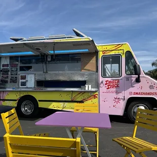 a colorful food truck parked in a parking lot