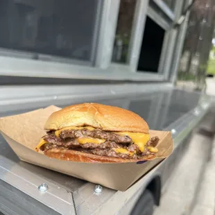 a cheeseburger sitting on a table