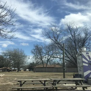 Patio lights, 3 tables, and corn hole set to enjoy the outdoors