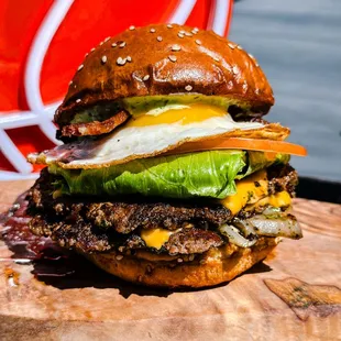 All-Star - two smashed patties, american cheese, iceberg lettuce, tomato, house onion, pickles, dunk sauce served on buttered sesame bun+egg