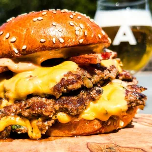 Triple double - triple smashed patties, double american cheese, thick bacon, dunk sauce served on buttered sesame bun.