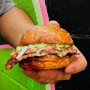 Pick and Roll - two smashed smoked sausage patties topped with smoked gouda cheese, house onions, dunk sauce served on buttered sesame bun.
