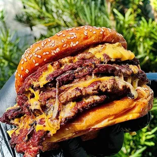 GOAT - six smashed patties, smoked gouda cheese, american cheese, dunk sauce served on buttered sesame bun.
