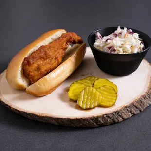 a hot dog with coleslaw and pickles