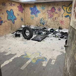 SmashLab rage room with printer, tire to use as prop, flatscreen TV, and 50 pieces of glass.