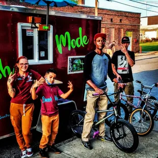 a group of people standing in front of a food truck