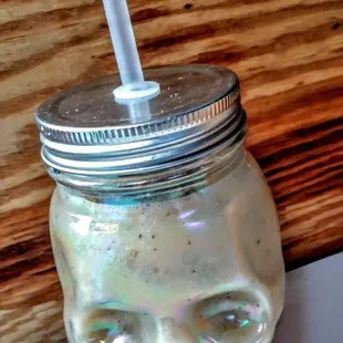 a glass jar with a straw in it