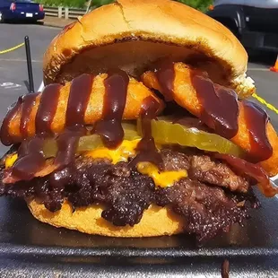 Backdoor BBQ.  Double French Onion Smash patties,  American cheese,  Bacon, Pickles, BBQ sauce, and battered Onion Rings.