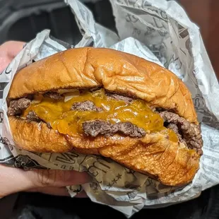 Triple patty smash burger with everything on it