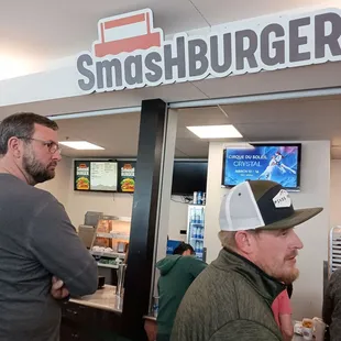 two men standing in front of a counter