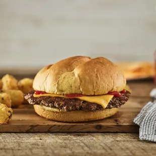 cheeseburger and tater tots on a cutting board