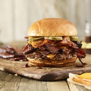 bacon, pickles, and cheese on a wooden cutting board