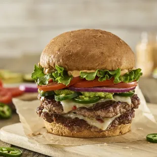 a hamburger with lettuce, tomato, and cheese