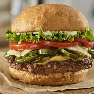 a hamburger with lettuce, tomato, and cheese