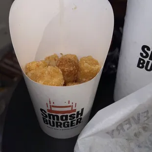 a container of fried food and a drink