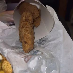 a fried chicken sandwich in a paper bag