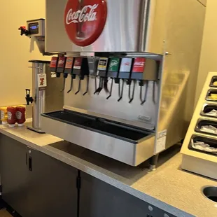 a soda dispenser in a commercial kitchen