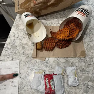 Burnt sweet potato fries, grease covered smash tots, stuck together ketchup packets by unknown substance, grease coated bag...