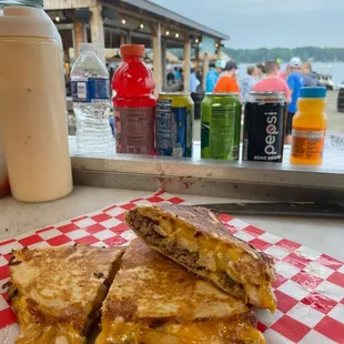  grilled cheese sandwich on a red and white checkered napkin