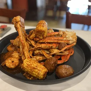 a plate of crab legs and corn on the cob