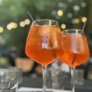 two glasses of drink on a table