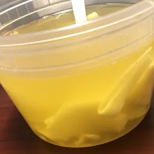 a plastic cup filled with yellow liquid