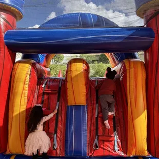 Fortress bounce house with double lane slide