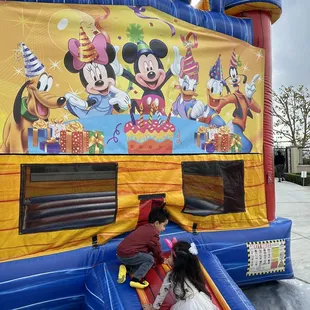 Fortress bounce house with double lane slide