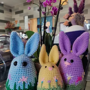 three crocheted easter bunnies on a counter