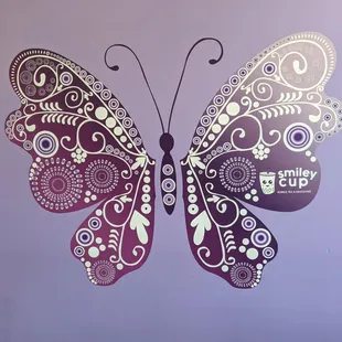 a purple and white butterfly on a purple background