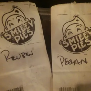 two paper bags with smiley pies written on them