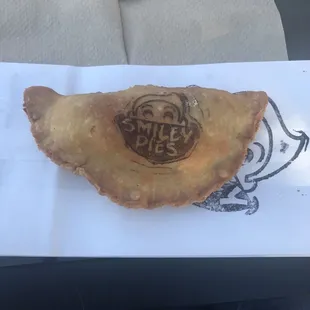 a smiley pie on a napkin