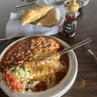 Cheese enchiladas with red mild sauce.