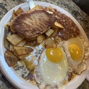 Christiana's Special (eggs, pork chop, beans, papitas, cheese enchiladas, green Chile and cheese). Came with a huge sopapilla, delicious