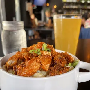 a bowl of food and a glass of beer