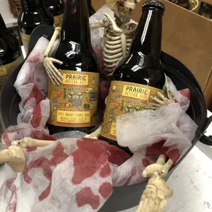 a skeleton holding a beer bottle