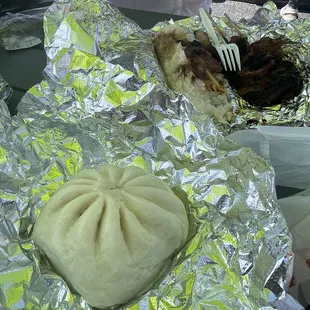 a plate of food wrapped in tin foil