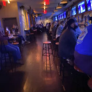 a group of people sitting at a bar