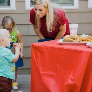 ws a woman and a young child at a table with food