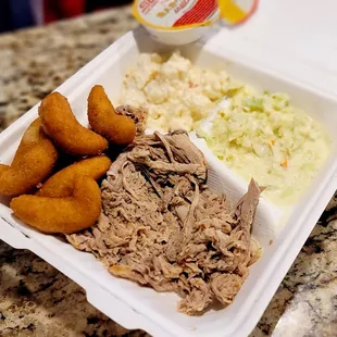 BBQ large plate with cole slaw, hush puppies and potato salad.