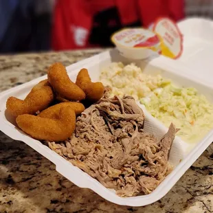 BBQ large plate with cole slaw, hush puppies and potato salad.