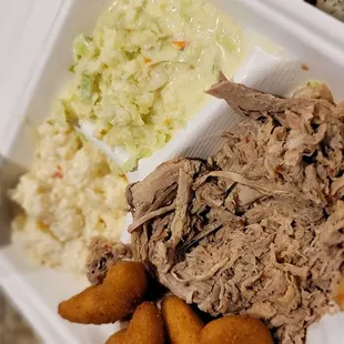 BBQ large plate with cole slaw, hush puppies and potato salad.