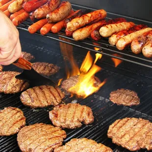 hamburgers and hot dogs cooking on a grill