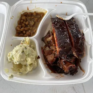 Two meat plate, ribs and brisket with baked beans and potato salad