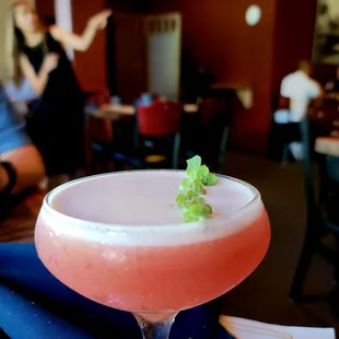  pink cocktail with a green garnish