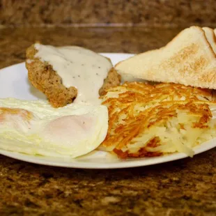 Country Fried Steak topped with White Gravy, Two eggs(your choice of how they are cooked), Hash Browns and Toast.