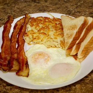 Traditional Bacon and Eggs with Hash Browns and Toast.